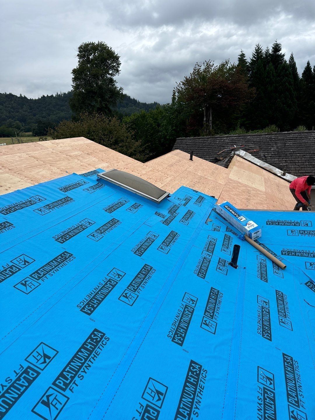 Roof repair experts restoring a damaged roof in Yelm after severe weather.