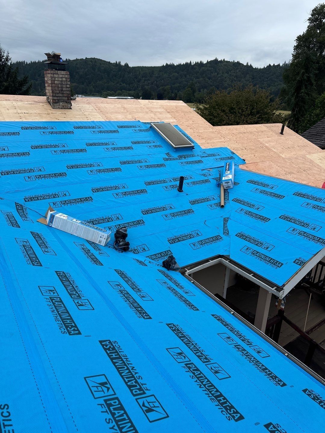 Roof repair experts restoring a damaged roof in Yelm after severe weather.