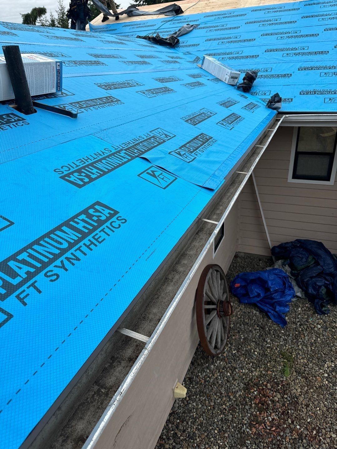 Roof repair experts restoring a damaged roof in Yelm after severe weather.