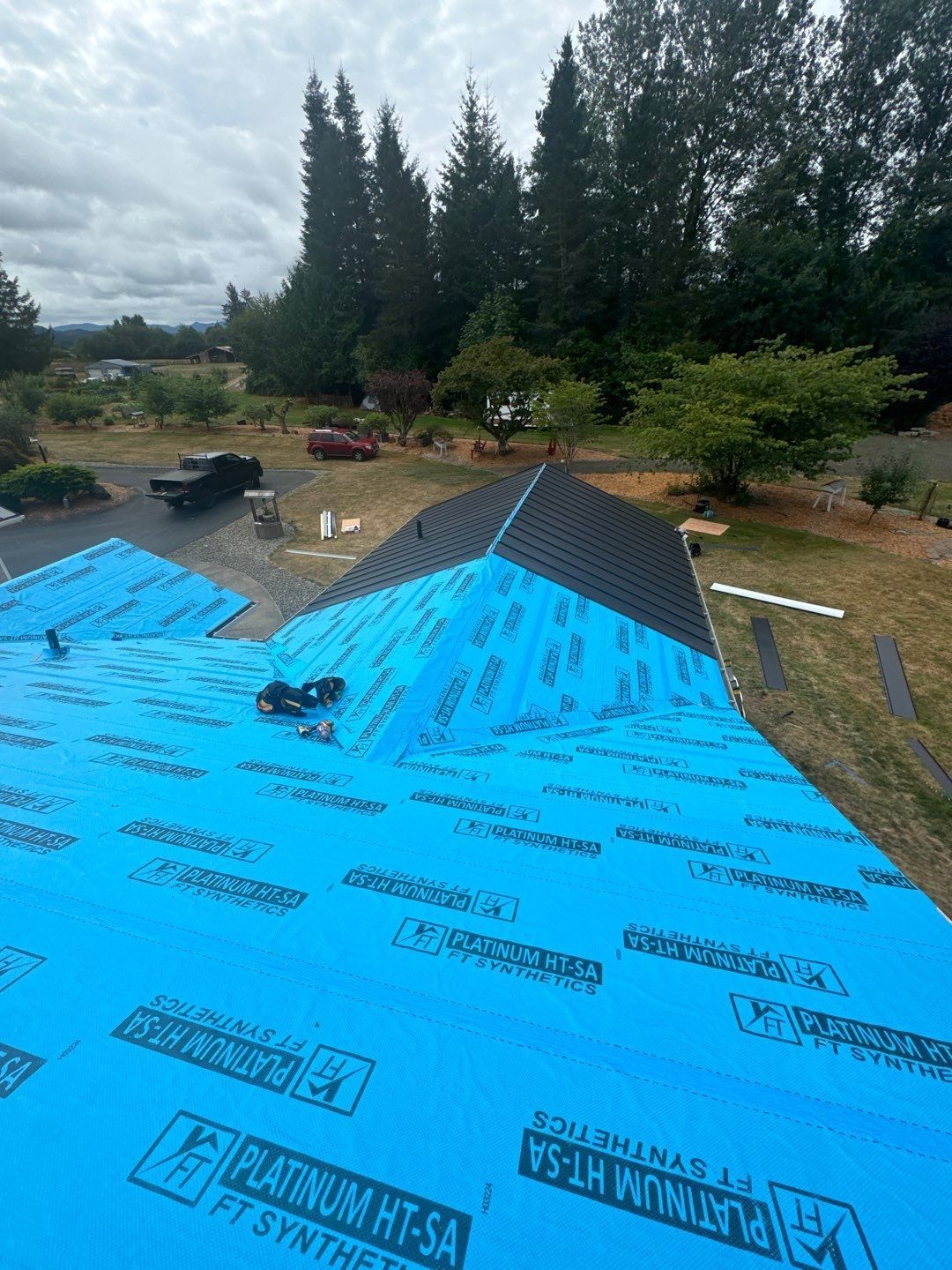 On Top Roofing crew working on a roof replacement project in Tumwater.