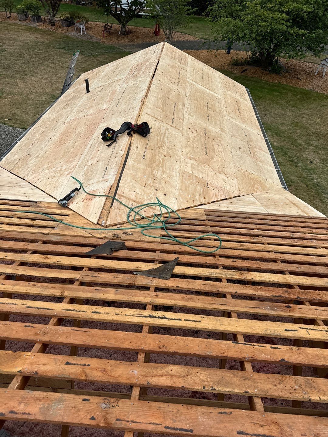 Roof repair experts restoring a damaged roof in Yelm after severe weather.