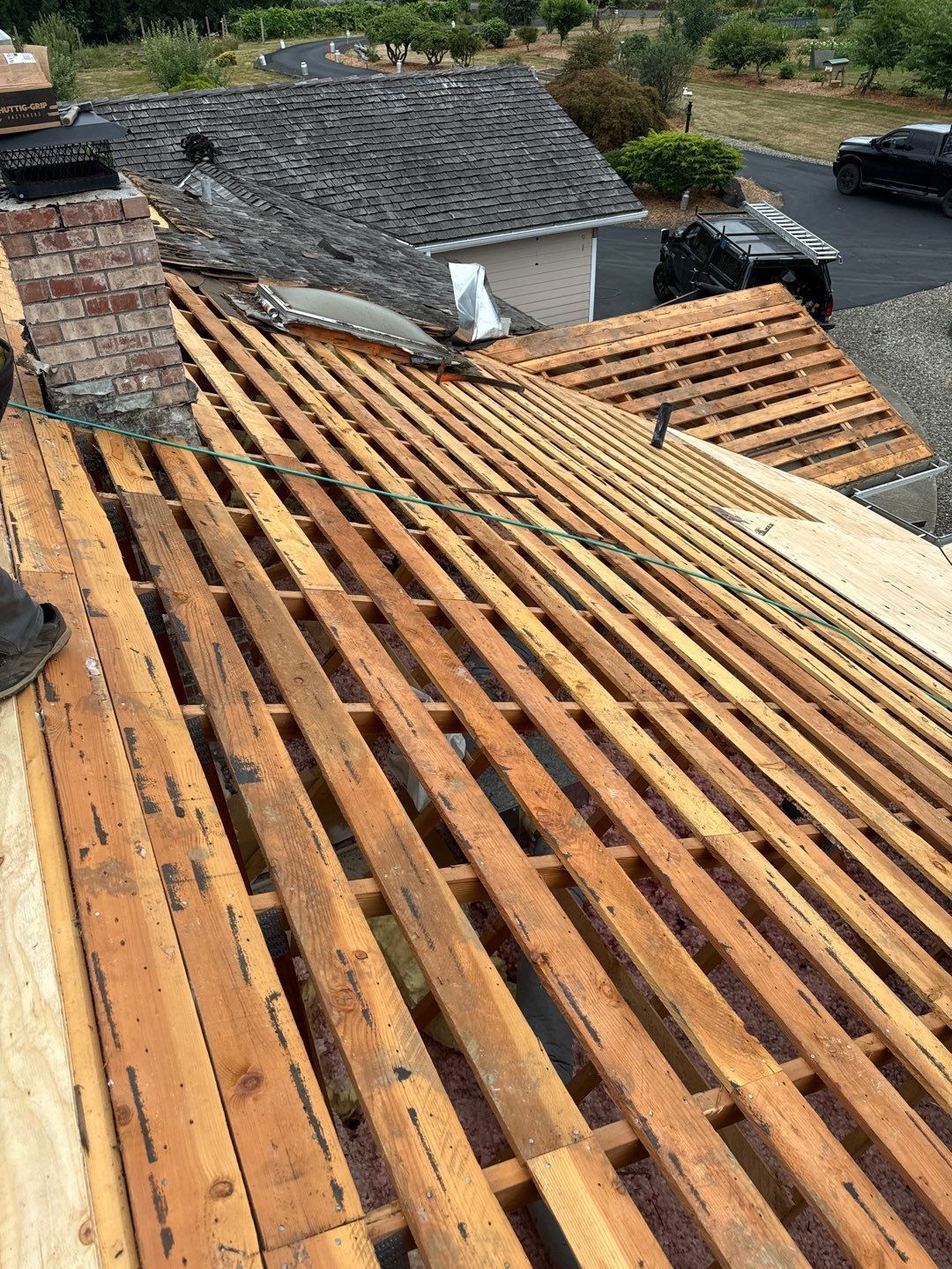 Roof repair experts restoring a damaged roof in Yelm after severe weather.