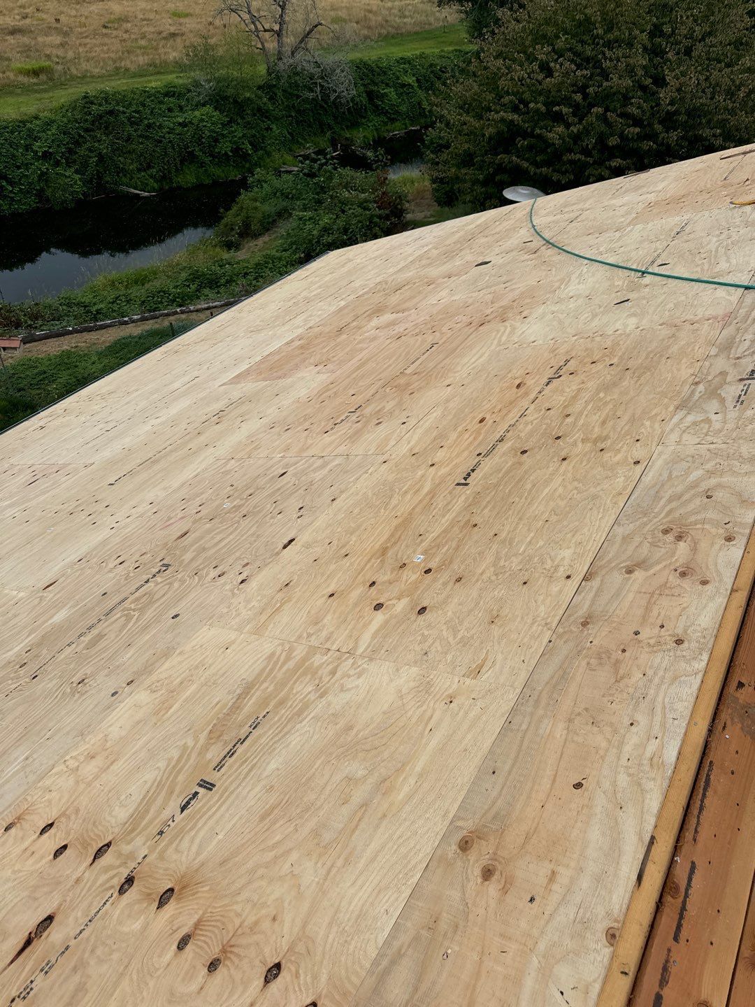 Roof repair experts restoring a damaged roof in Yelm after severe weather.
