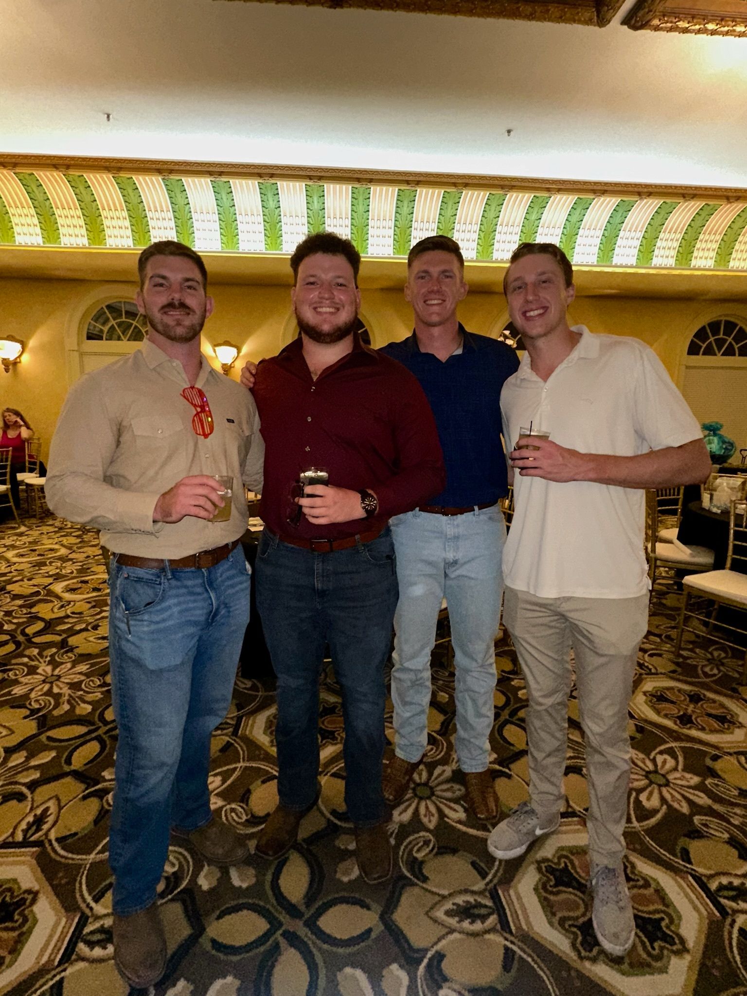 A group of young men are posing for a picture in a room.