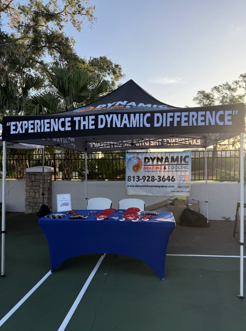 A table under a canopy that says `` experience the dynamic difference ''.