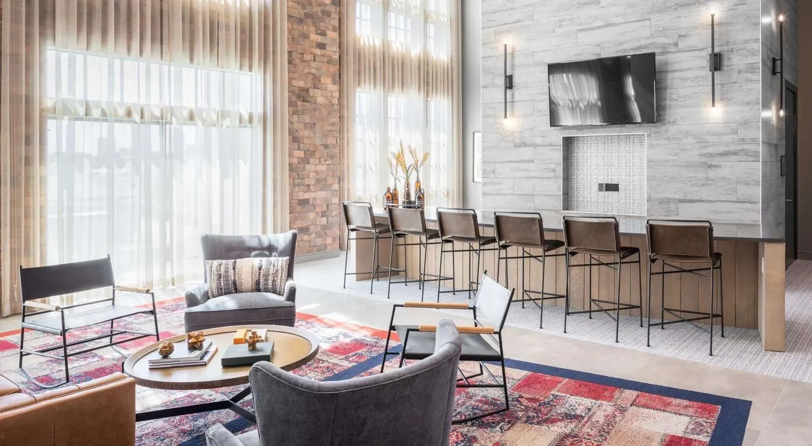 Modern lounge area with a bar and seating.