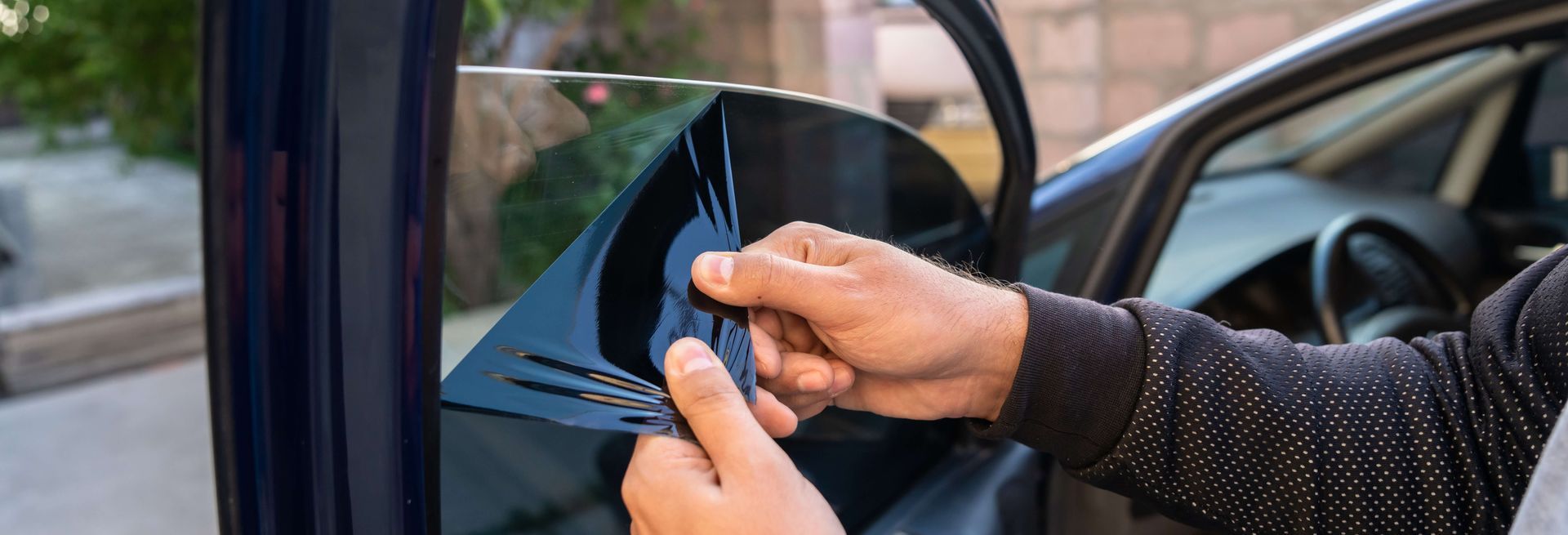 Person using a credit card to open a car door with a touchscreen handle