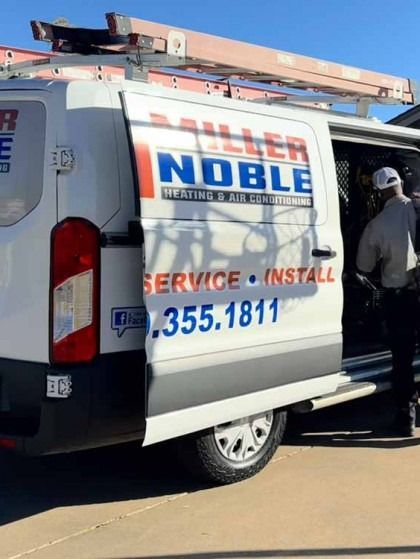 White service van with “Noble” logo, ladder on top, and a worker standing by the open side door.