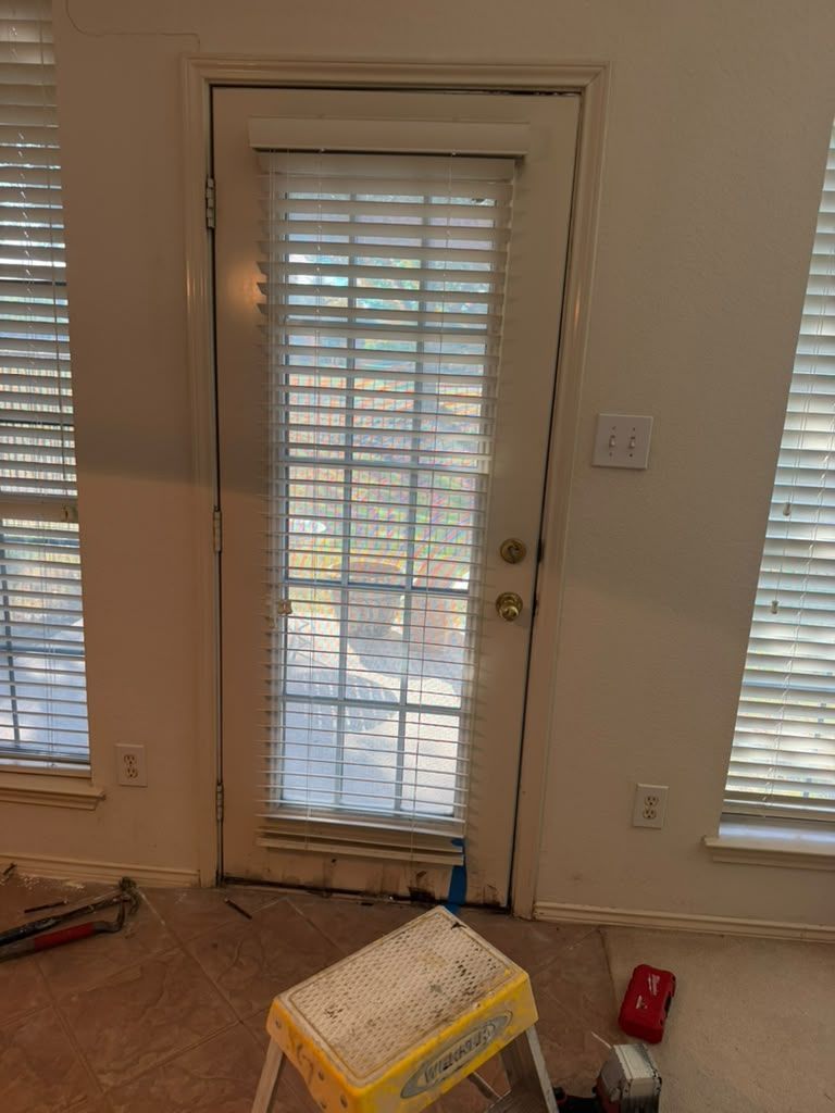 Interior room with a glass back door, windows with blinds, and a yellow step stool on the floor.
