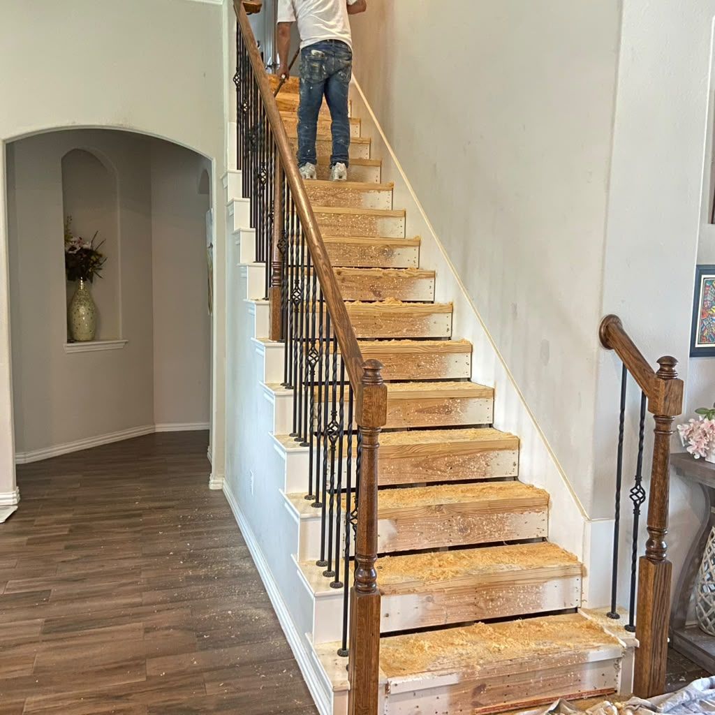 Wooden staircase in a home interior, with a person ascending near the top.