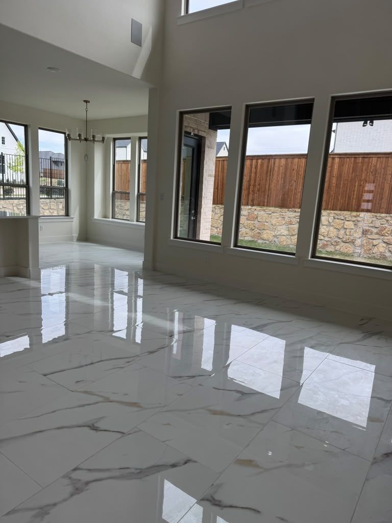 Bright modern living room with glossy marble floor, large windows, and high ceilings
