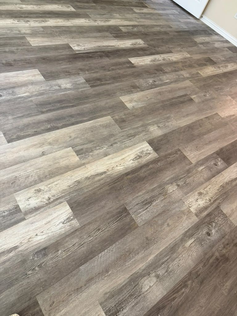 Empty room with gray-brown wood-look flooring