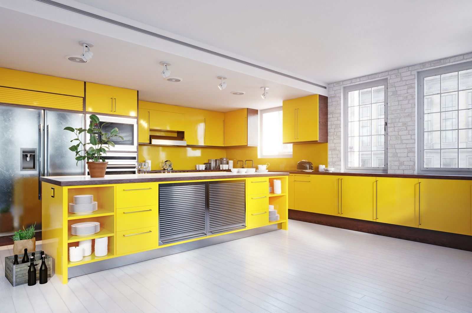 Bright yellow modern kitchen with island, stainless steel appliances, and large windows