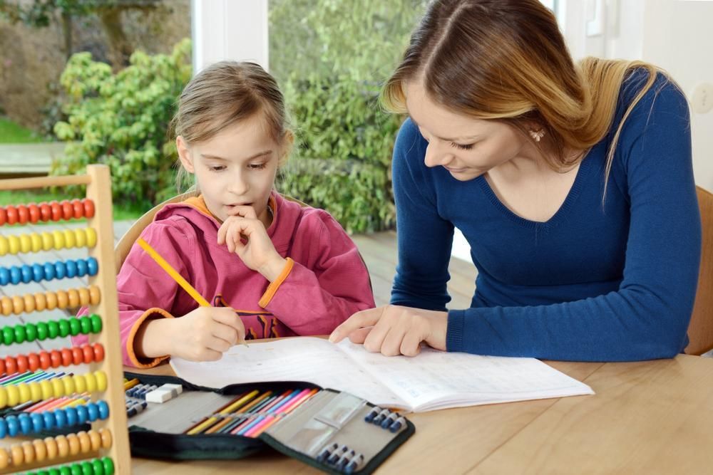 A Woman Is Helping a Little Girl with Her Homework — Al Roberts Education Centre in Wynnum West, QLD