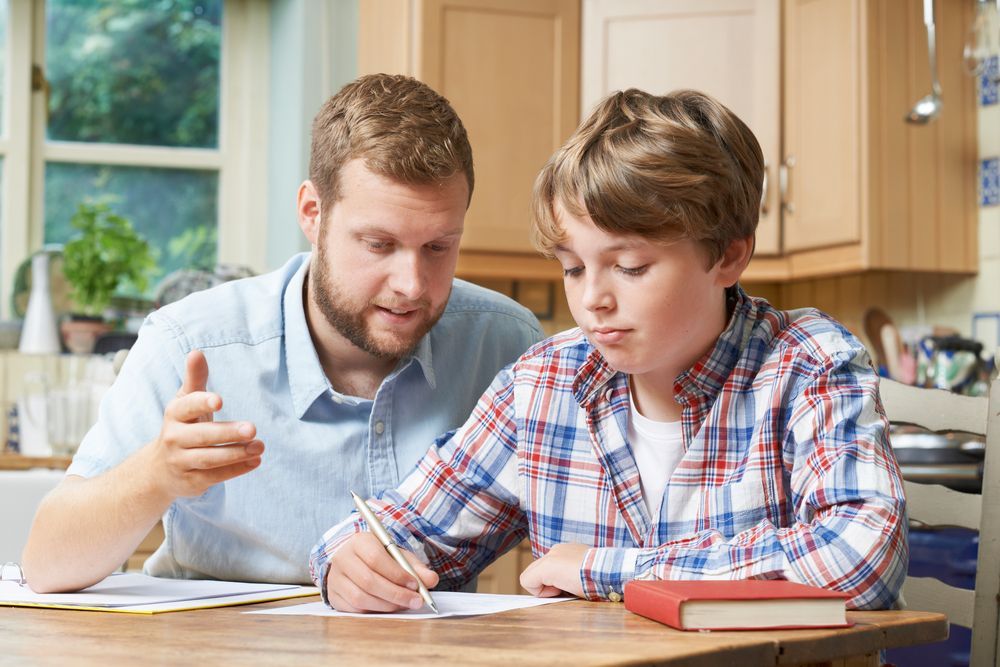 Male Tutor Helping Boy With His Studies — Al Roberts Education Centre in Wynnum West, QLD