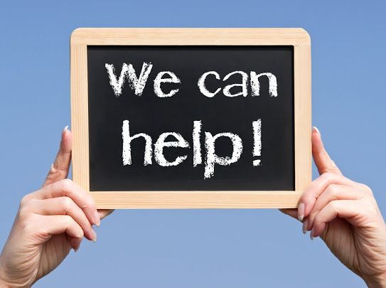 A person is holding a sign that says we can help — Al Roberts Education Centre in Wynnum West, QLD