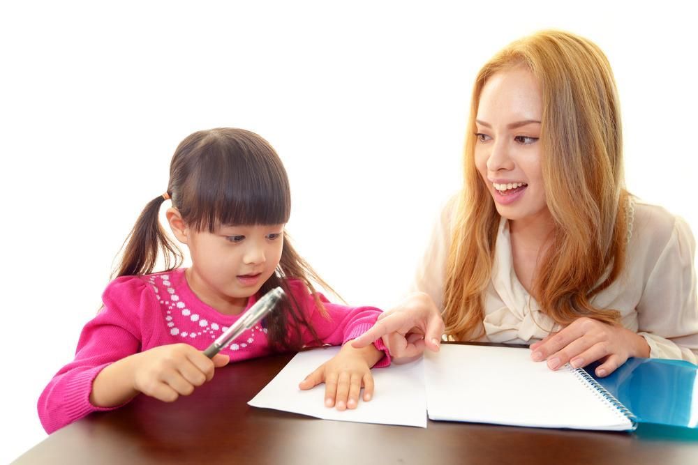 A Woman Is Helping a Little Girl with Her Homework — Al Roberts Education Centre in Wynnum West, QLD