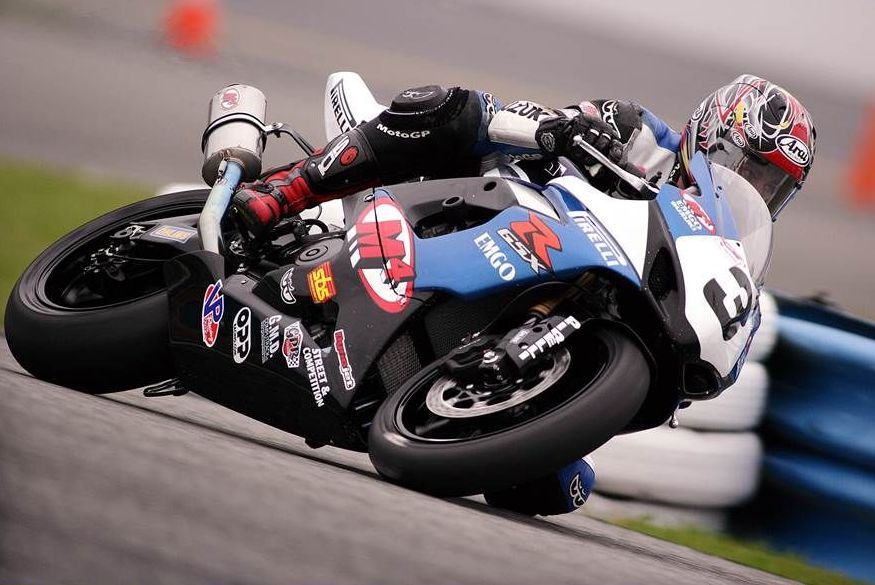 A person riding a motorcycle with the number 13 on it