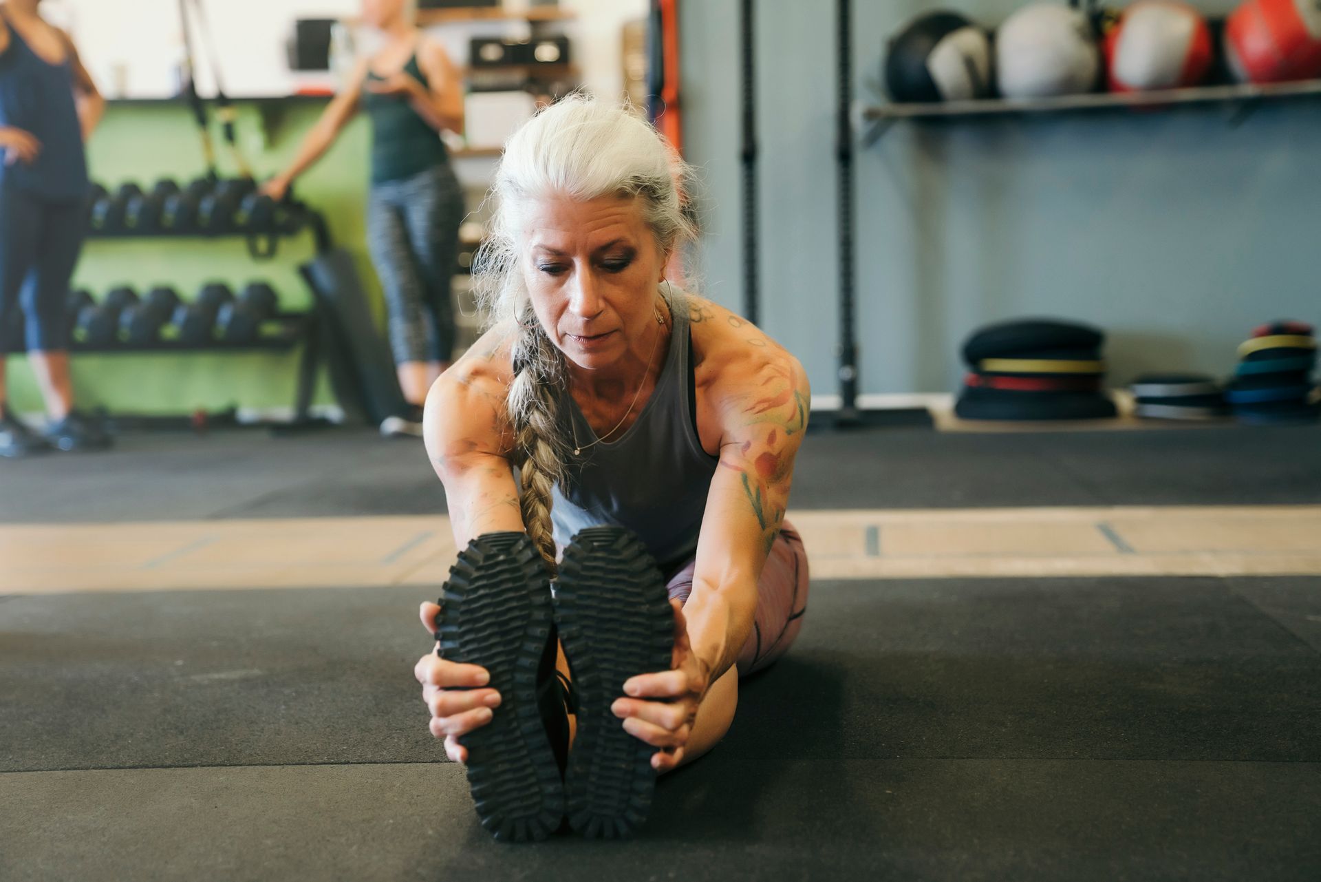 Old Women Doing Stretching — Goodyear, AZ — Natalie's Fitness Elements Garage Old Women Doing Stretching — Goodyear, AZ — Natalie's Fitness Elements Garage