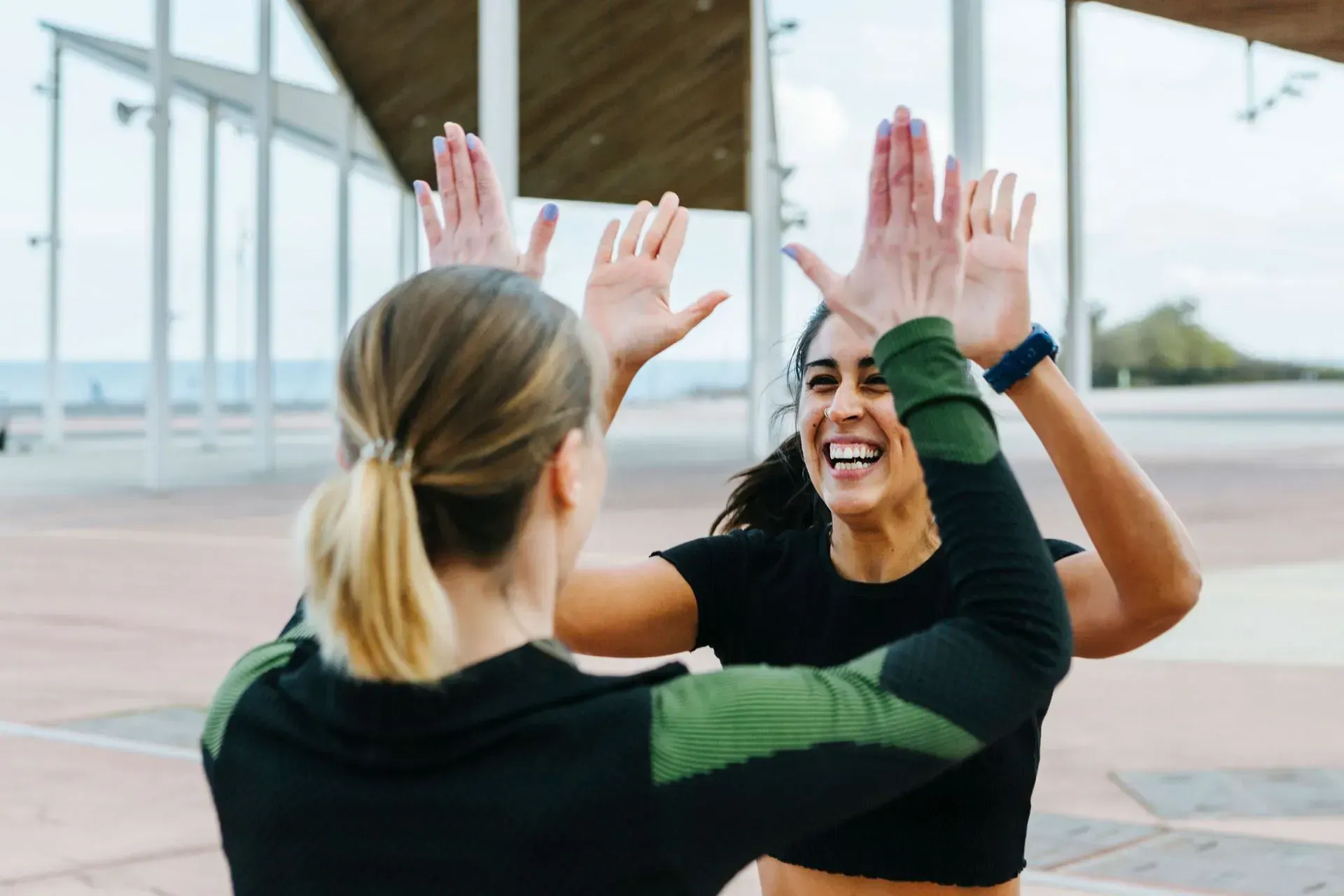 Two Women Doing High Five — Goodyear, AZ — Natalie's Fitness Elements Garage Two Women Doing High Five — Goodyear, AZ — Natalie's Fitness Elements Garage
