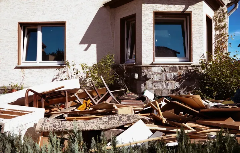 A house with a lot of rubble in front of it.