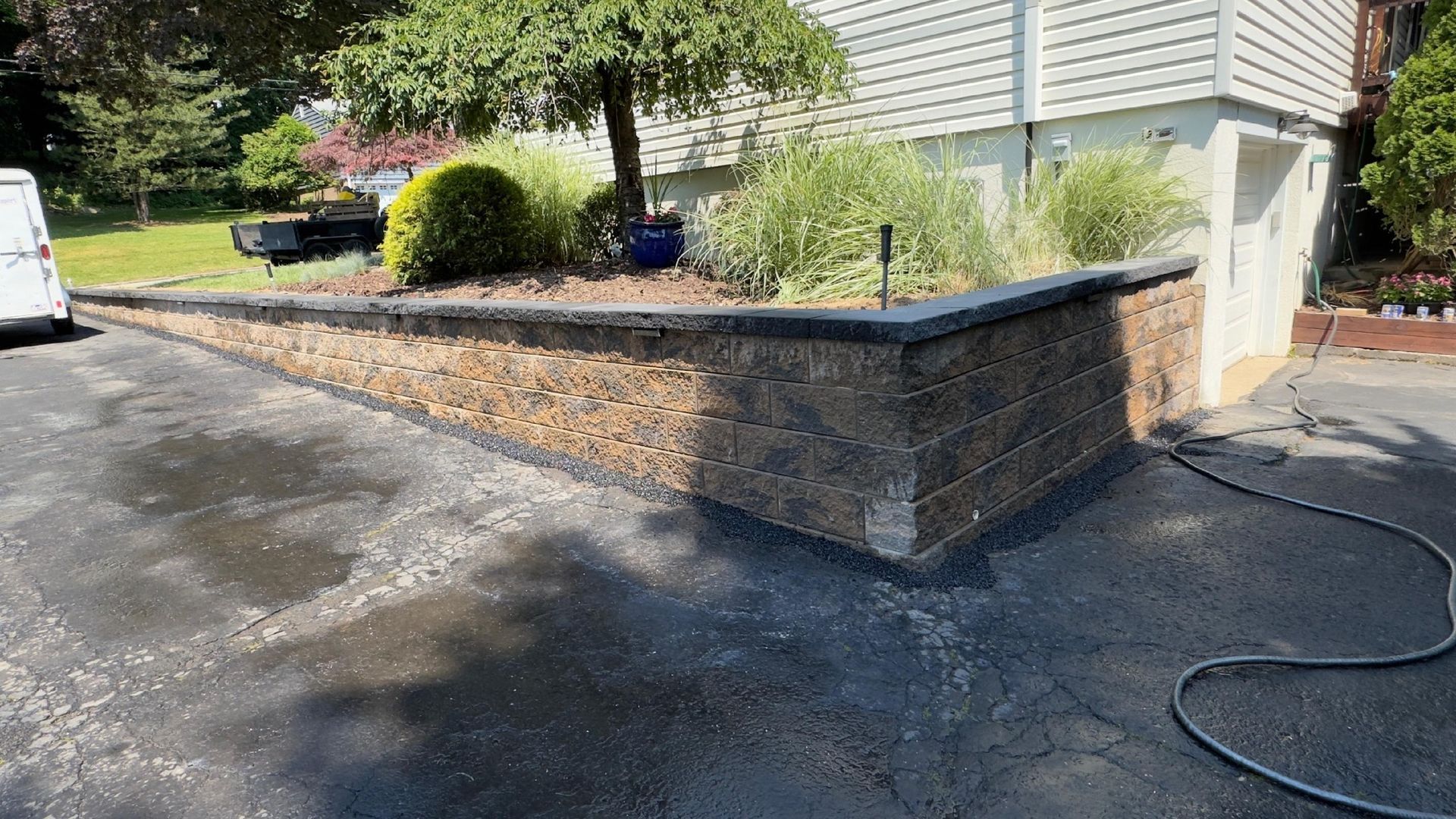 Construction workers placing large stone blocks to build a retaining wall. Construction workers placing large stone blocks to build a retaining wall.