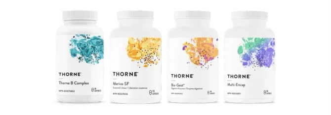 Four bottles of thorne vitamins are lined up next to each other on a white background.