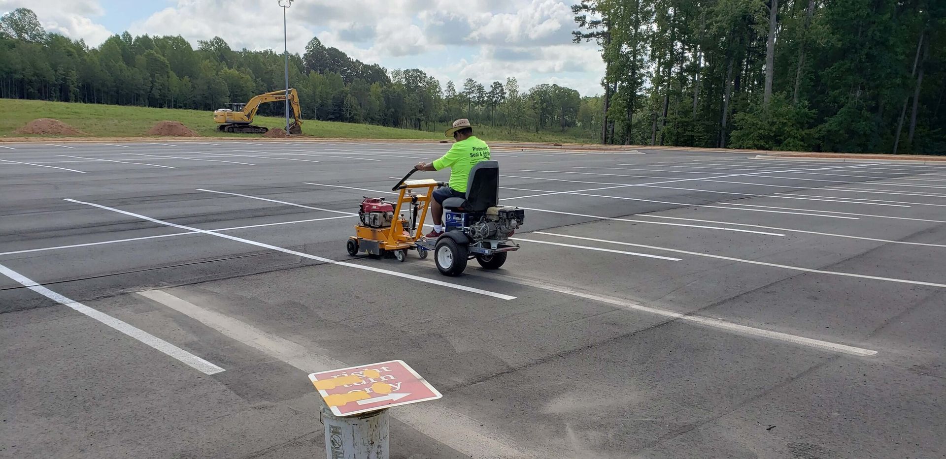 A group of people are standing in a parking lot.