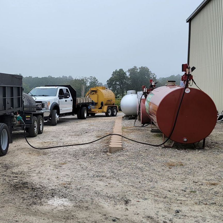 A truck is being fueled by a propane tank