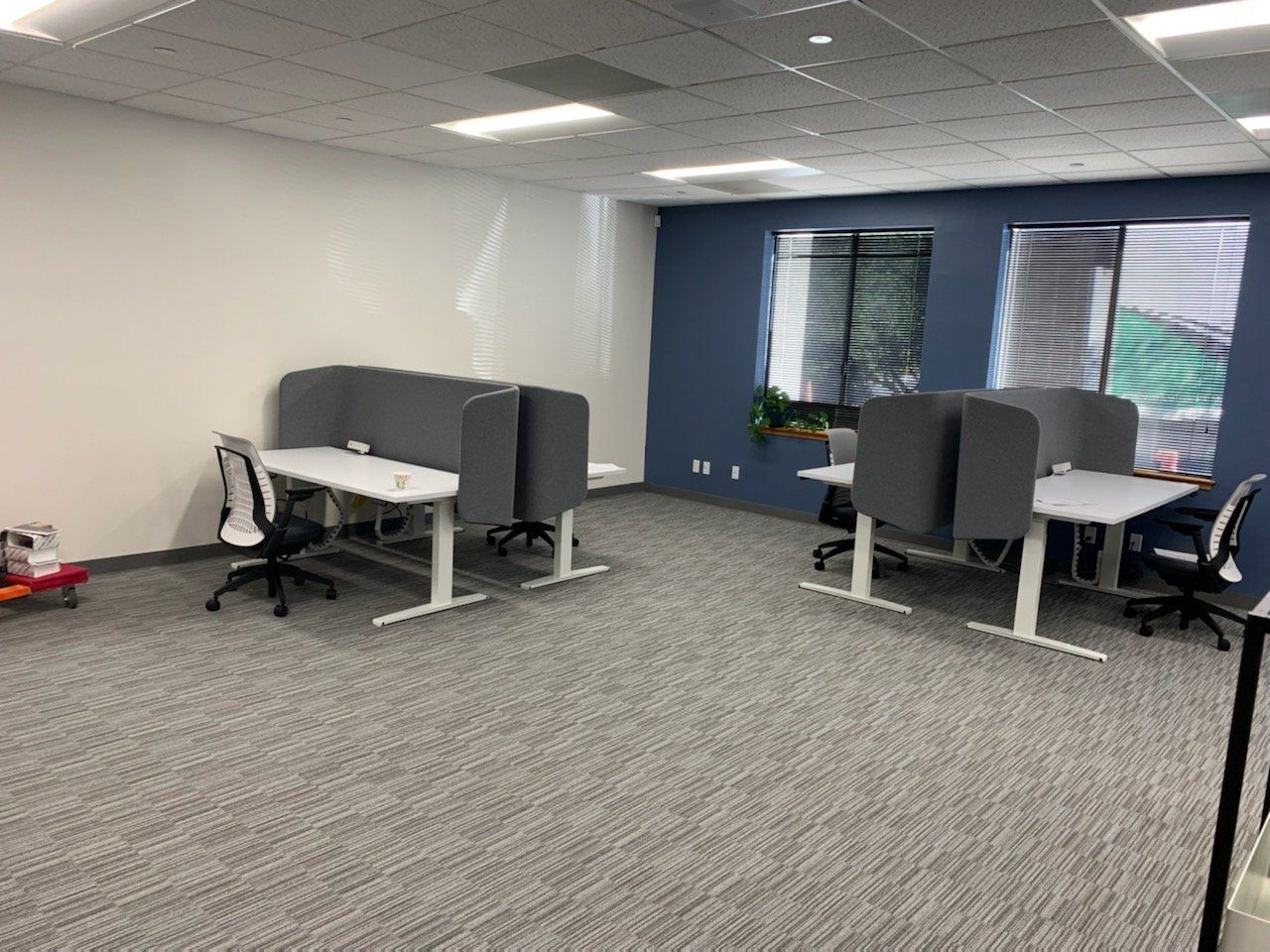 A room with a lot of desks and chairs in it.