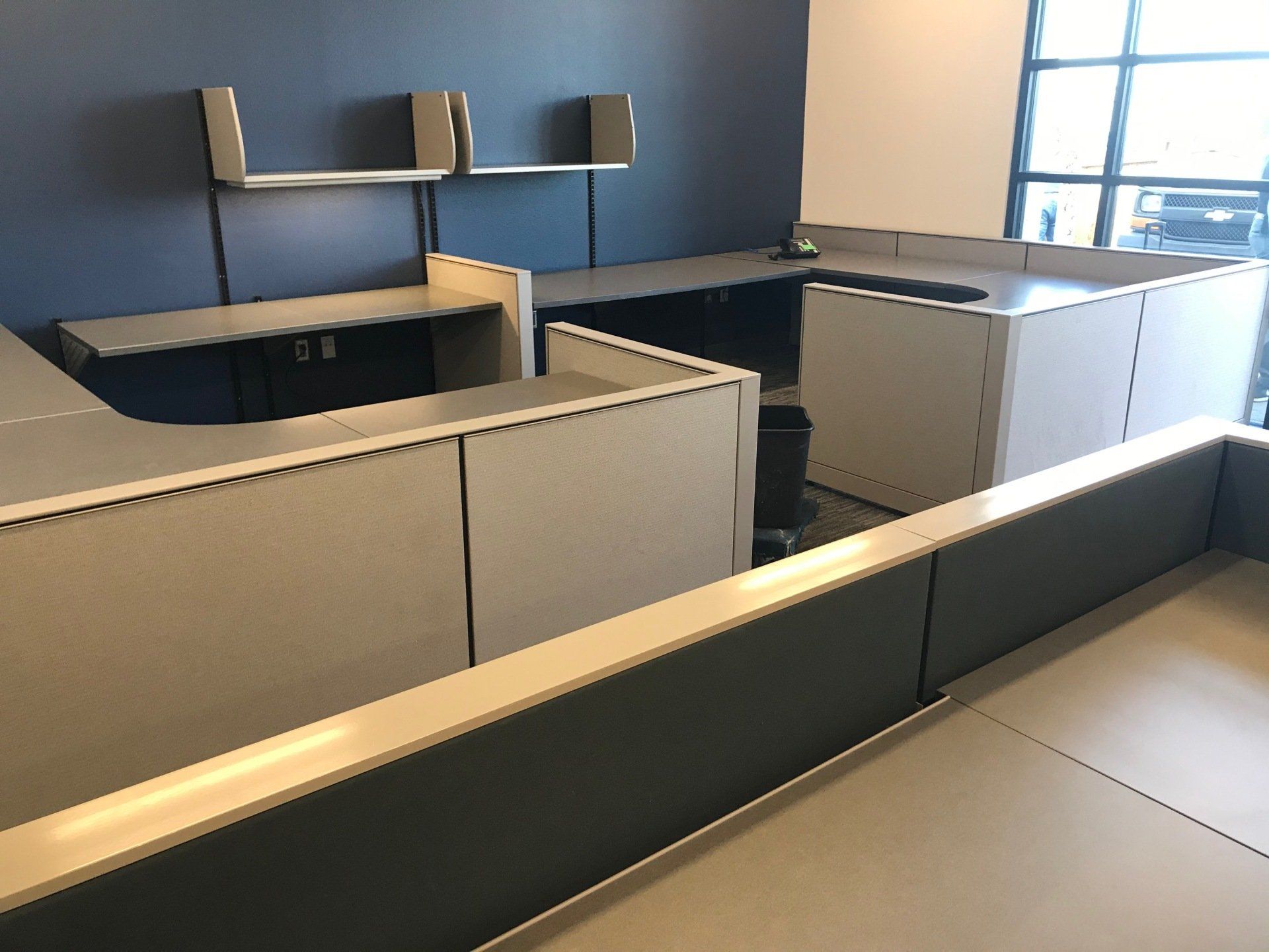 An empty office with cubicles and a window