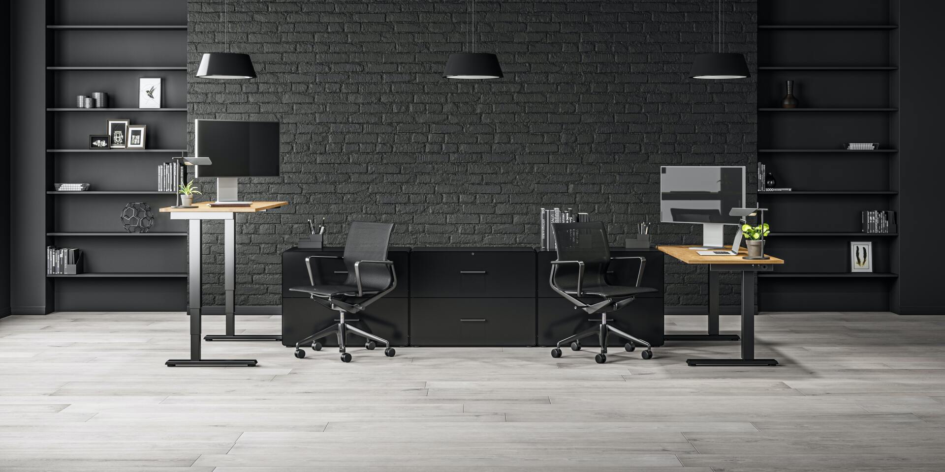 A modern office with a black brick wall and two standing desks.