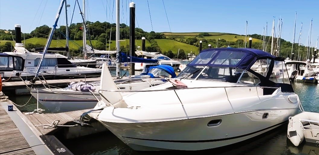 A peaceful marina filled with docked boats, including recently upgraded vessels