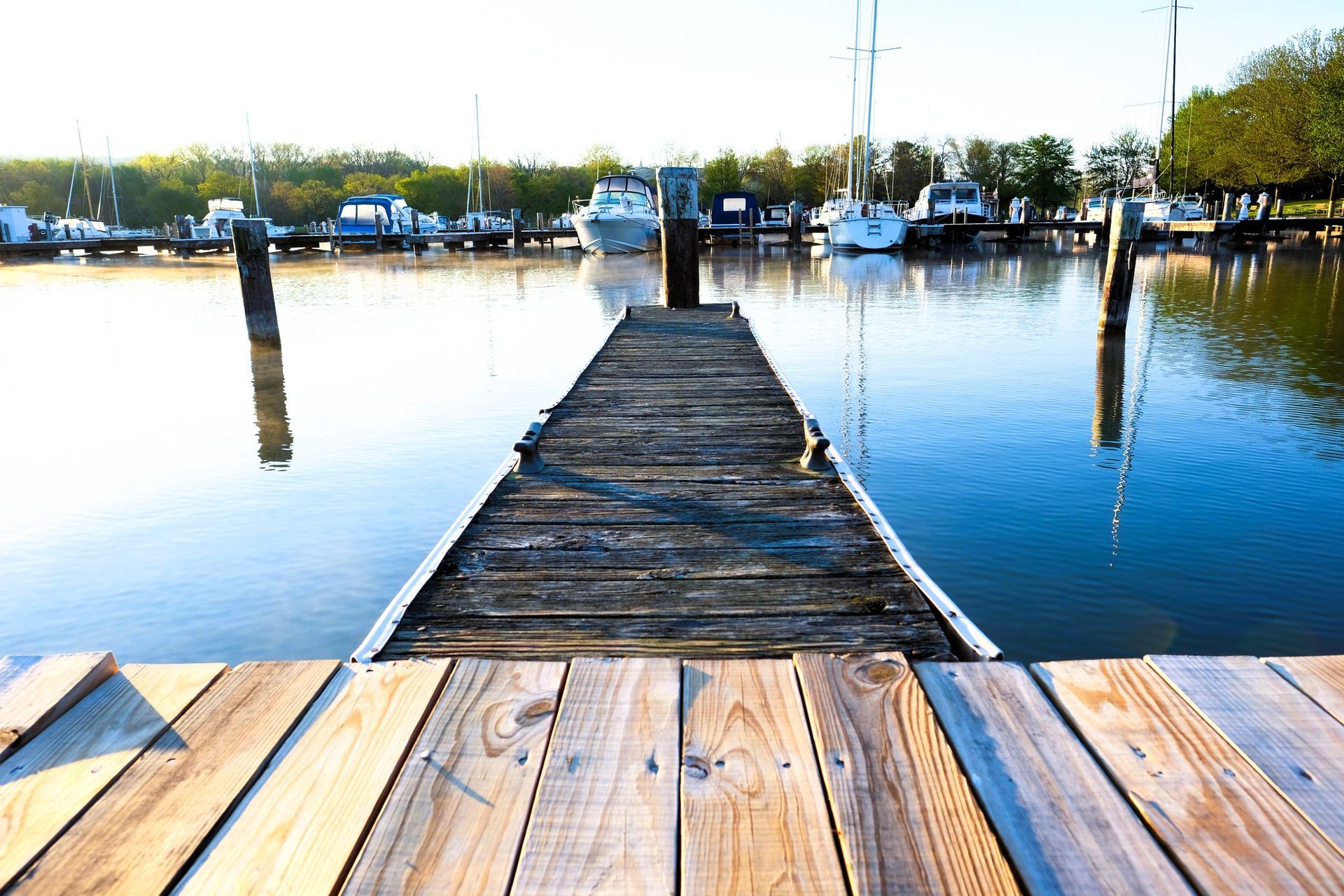 Wooden dock with boats in marina during seasonal maintenance in Tampa