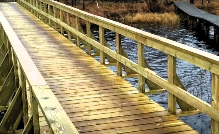 Tampa waterfront wooden boardwalk with railing over water, professional construction for durability and safety