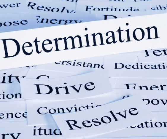 The word determination is on a piece of paper