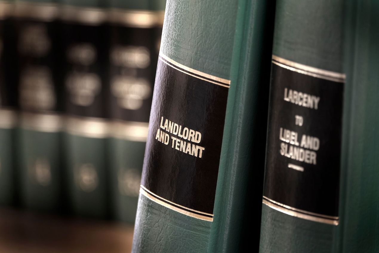 A row of green law books on a shelf, focusing on spines labeled