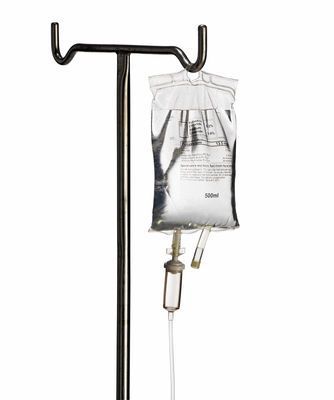 IV pole holding a clear IV bag with tubing and drip chamber
