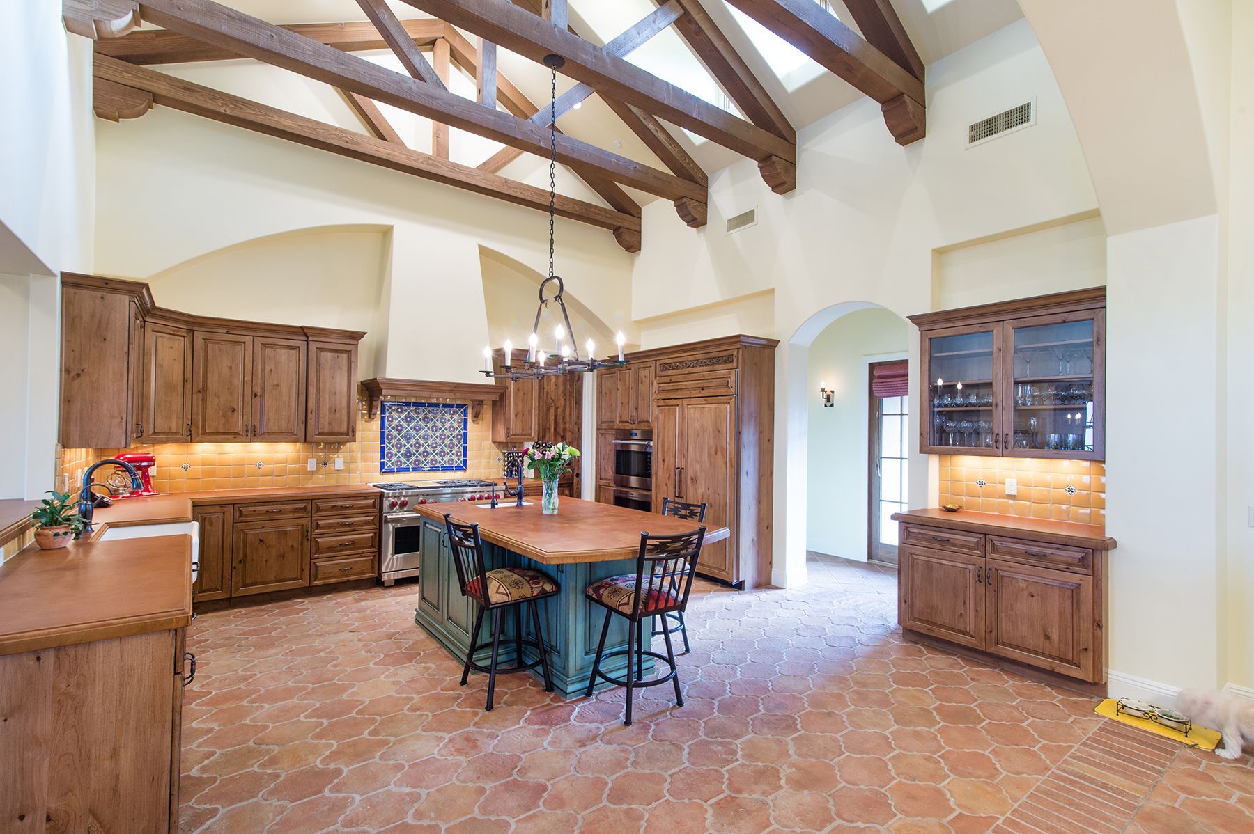 A large kitchen with wooden cabinets and a large island.