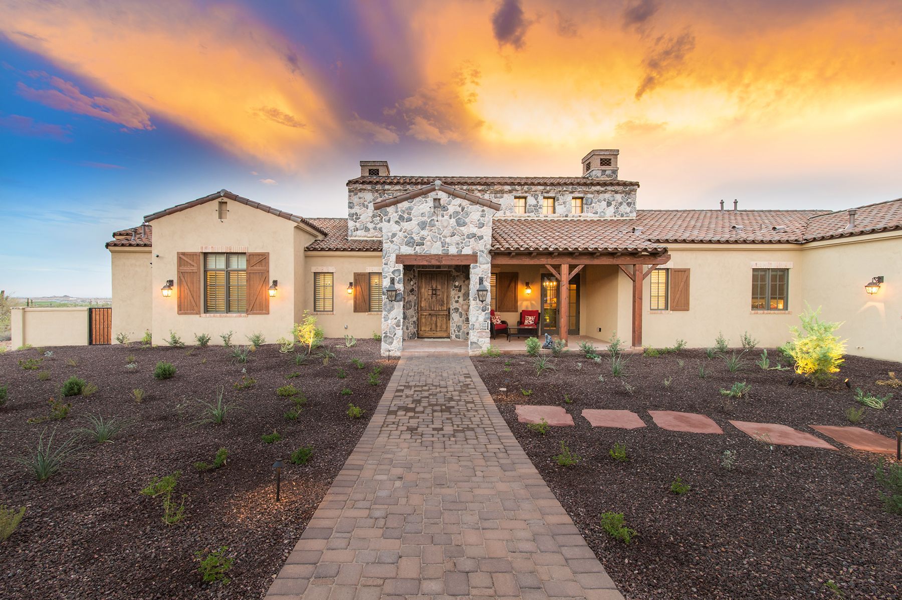 A large house with a brick walkway leading to it.