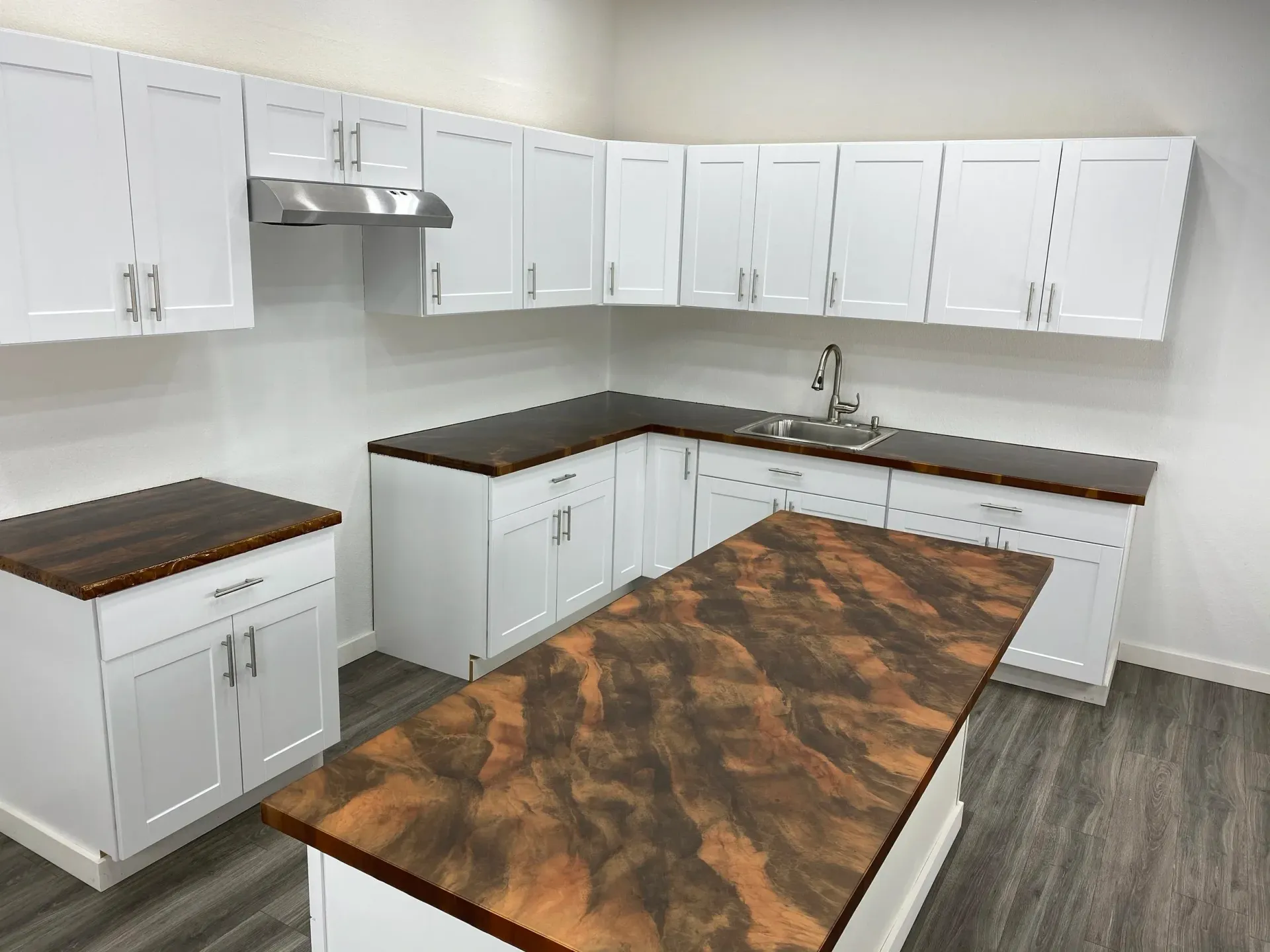 Reception area with reception desk and seating; gray marble-look floors, white and gray accents.