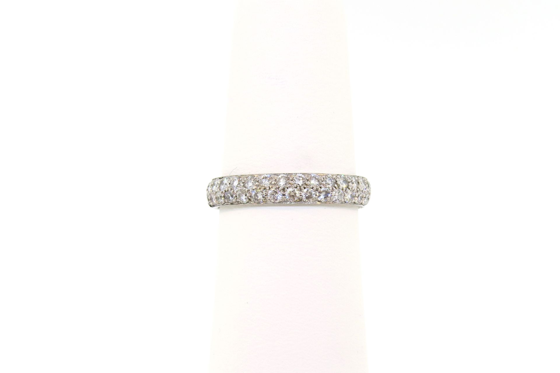 Diamond-studded silver ring on a white background