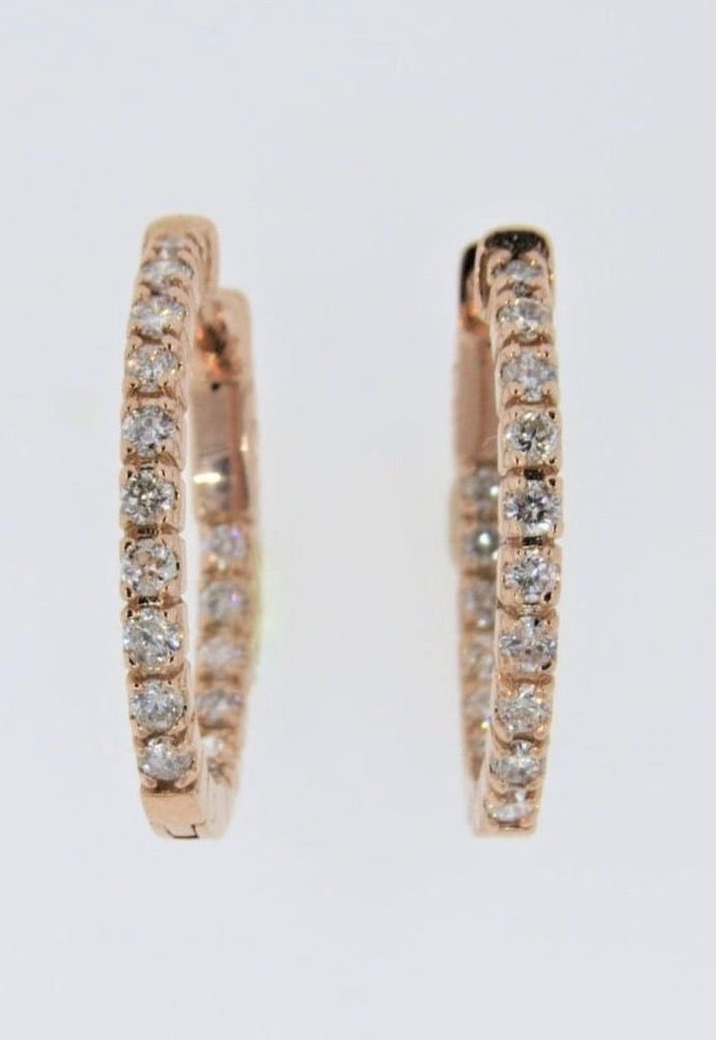 Gold ring with small clear stones in a row on a white background
