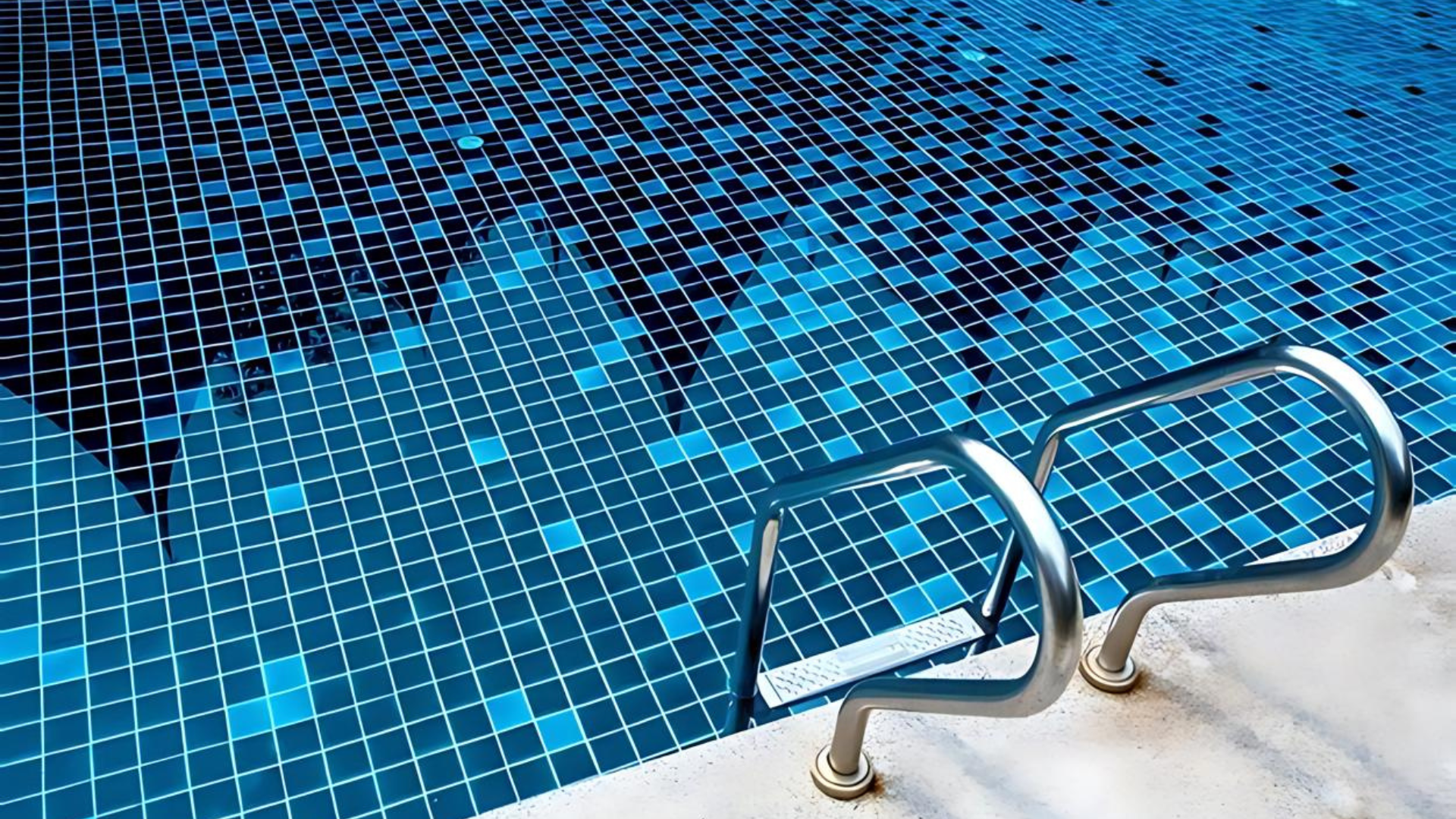 A swimming pool with blue tiles and stairs leading to it.