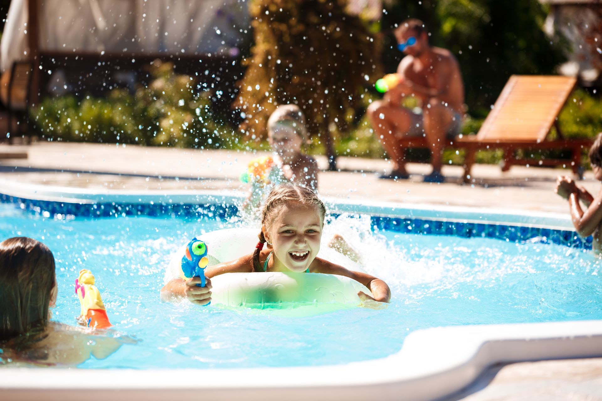 A group of children are playing in a swimming pool.