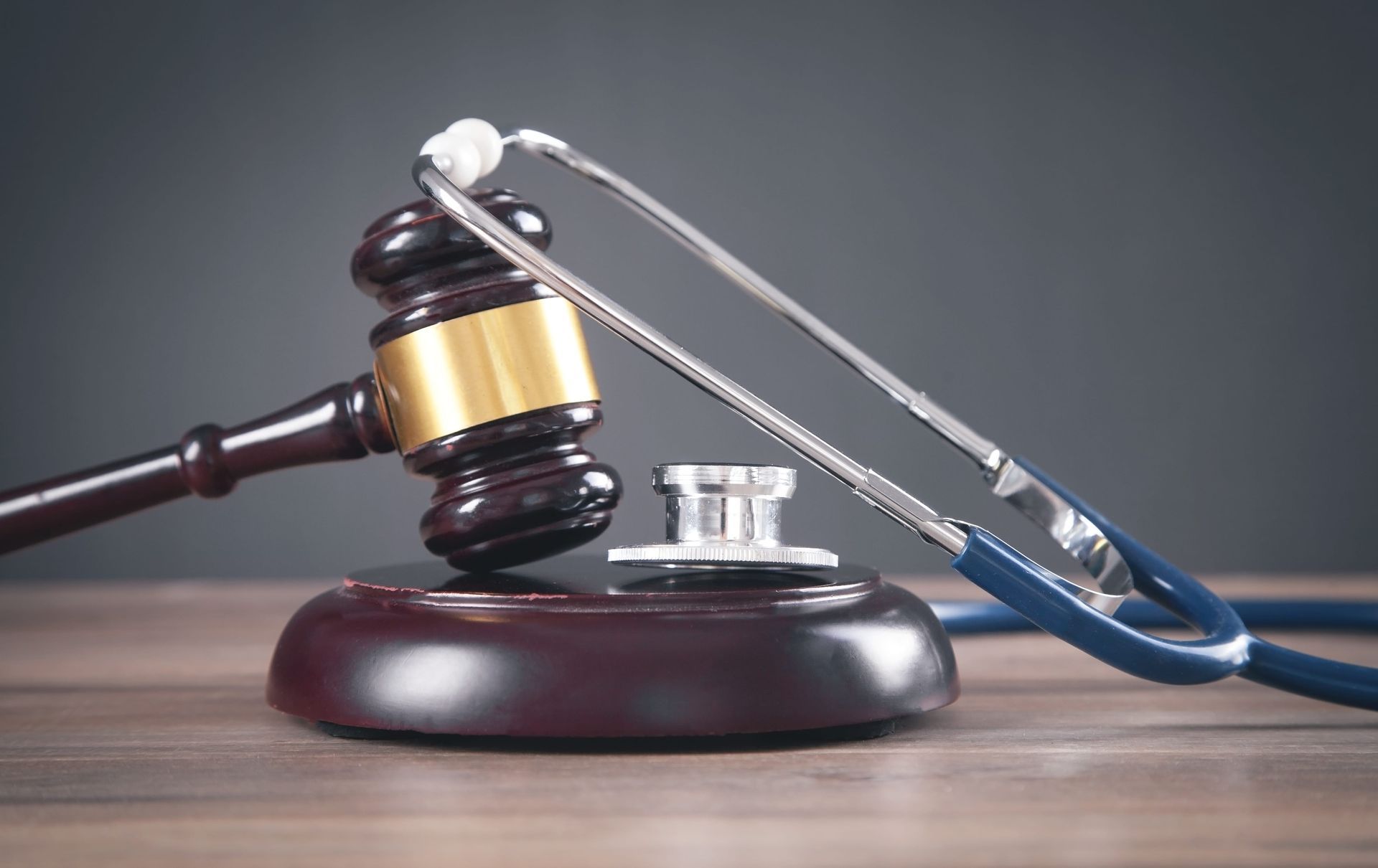 Judge’s gavel and stethoscope on a desk, symbolizing medical malpractice or healthcare law