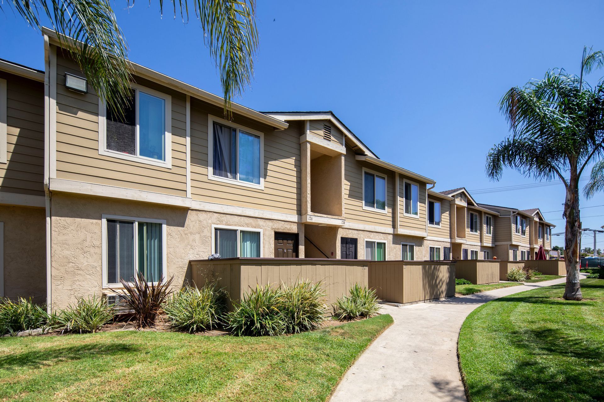 a row of apartment buildings on a sunny day