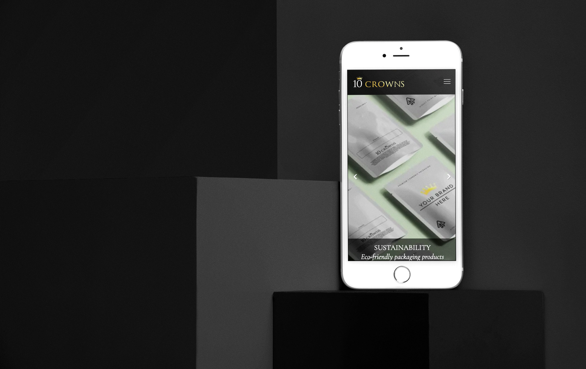 a white cell phone displays the 10 Crowns websitee homepage