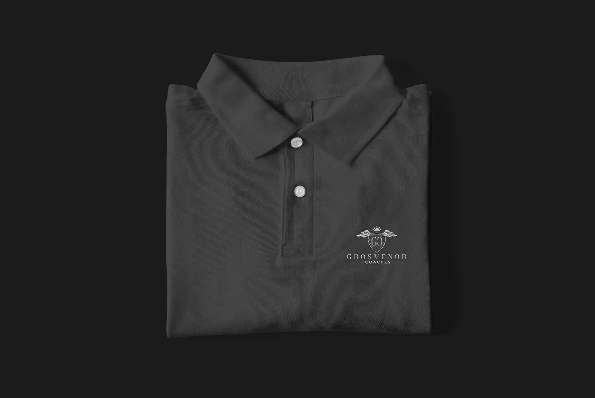 A grey Grosvenor Coaches polo shirt folded up
