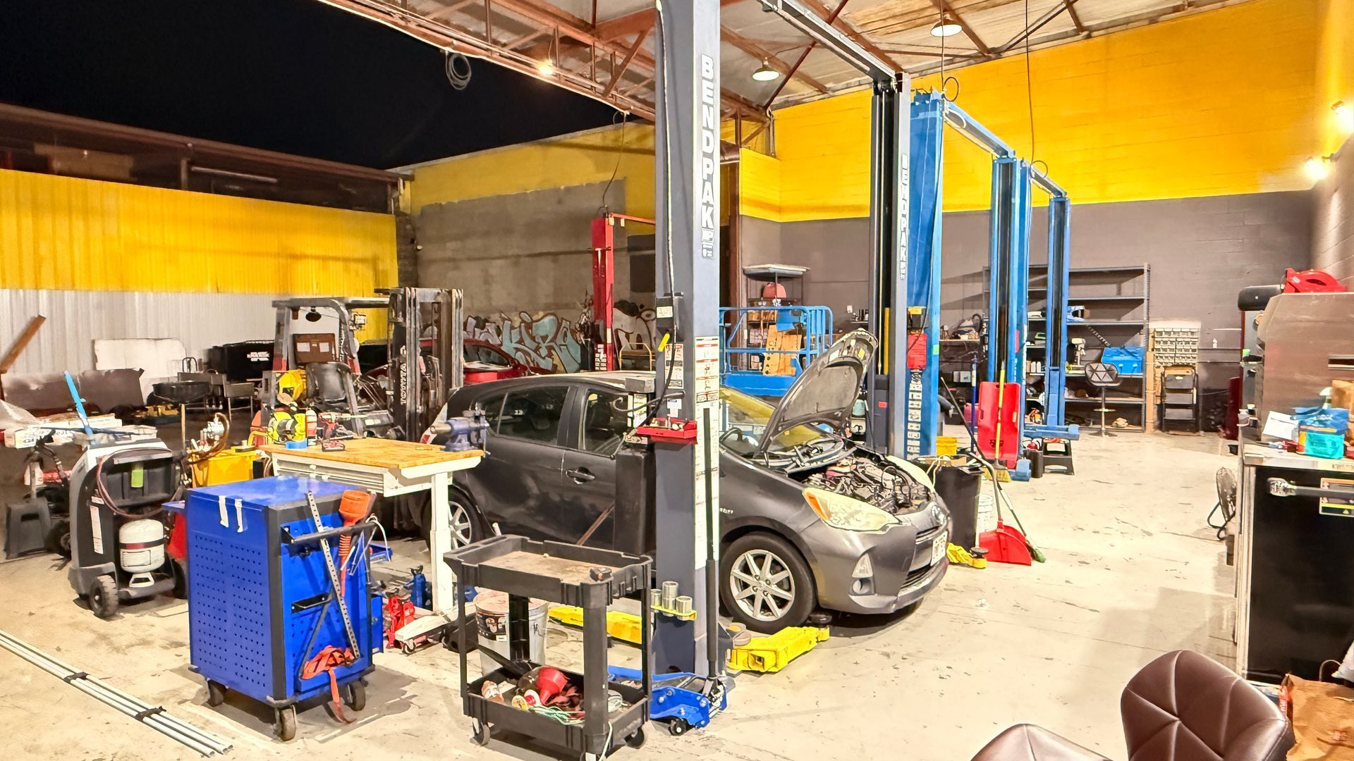 Auto repair shop with cars on lifts, tools, and equipment | Sky Auto Express